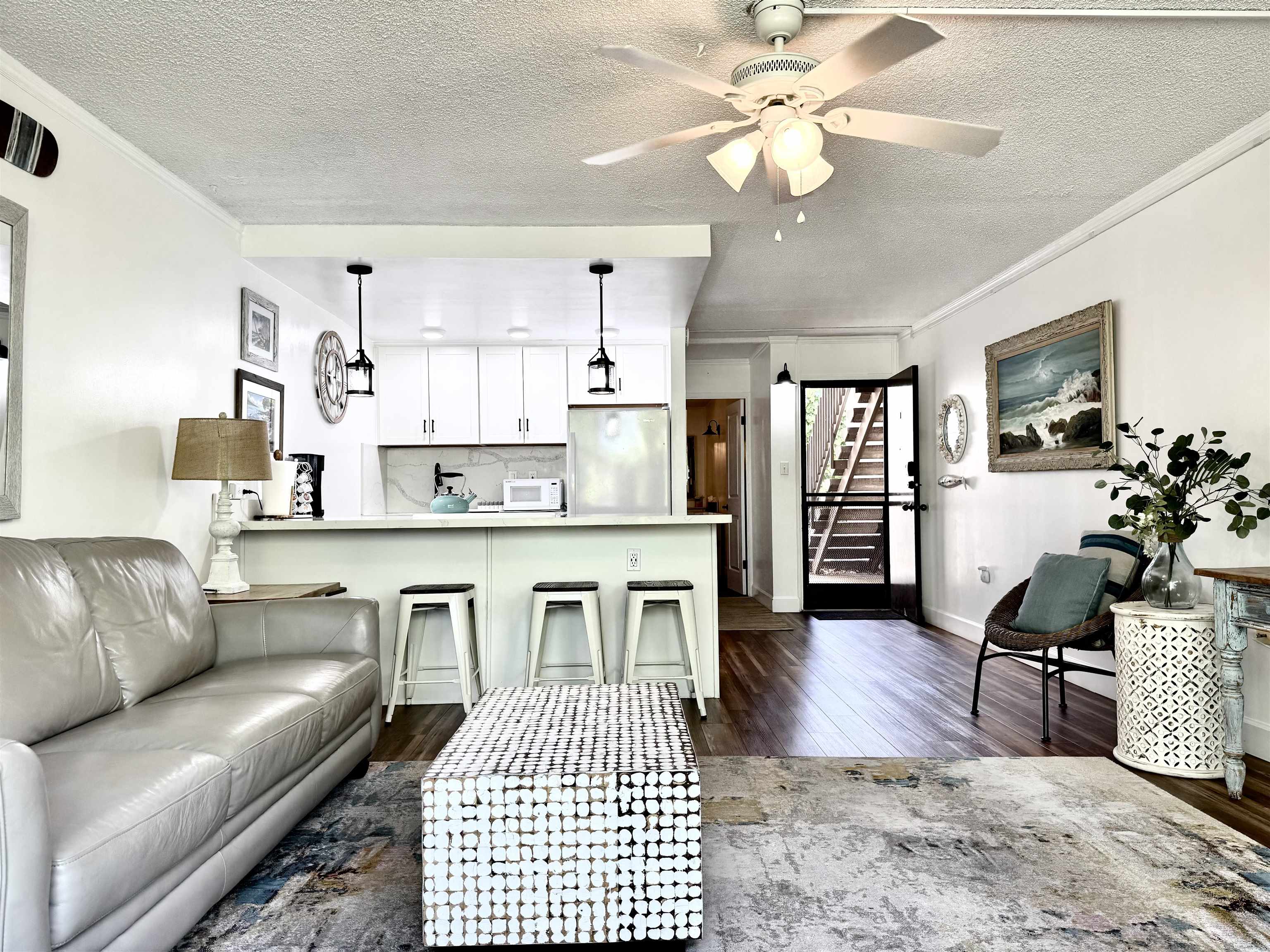 120 Hui Rd F, Unit B5 Lahaina, HI 96761 - Photo 6 of 17 a kitchen with granite countertop a stove a sink a dining table and chairs with wooden floor
