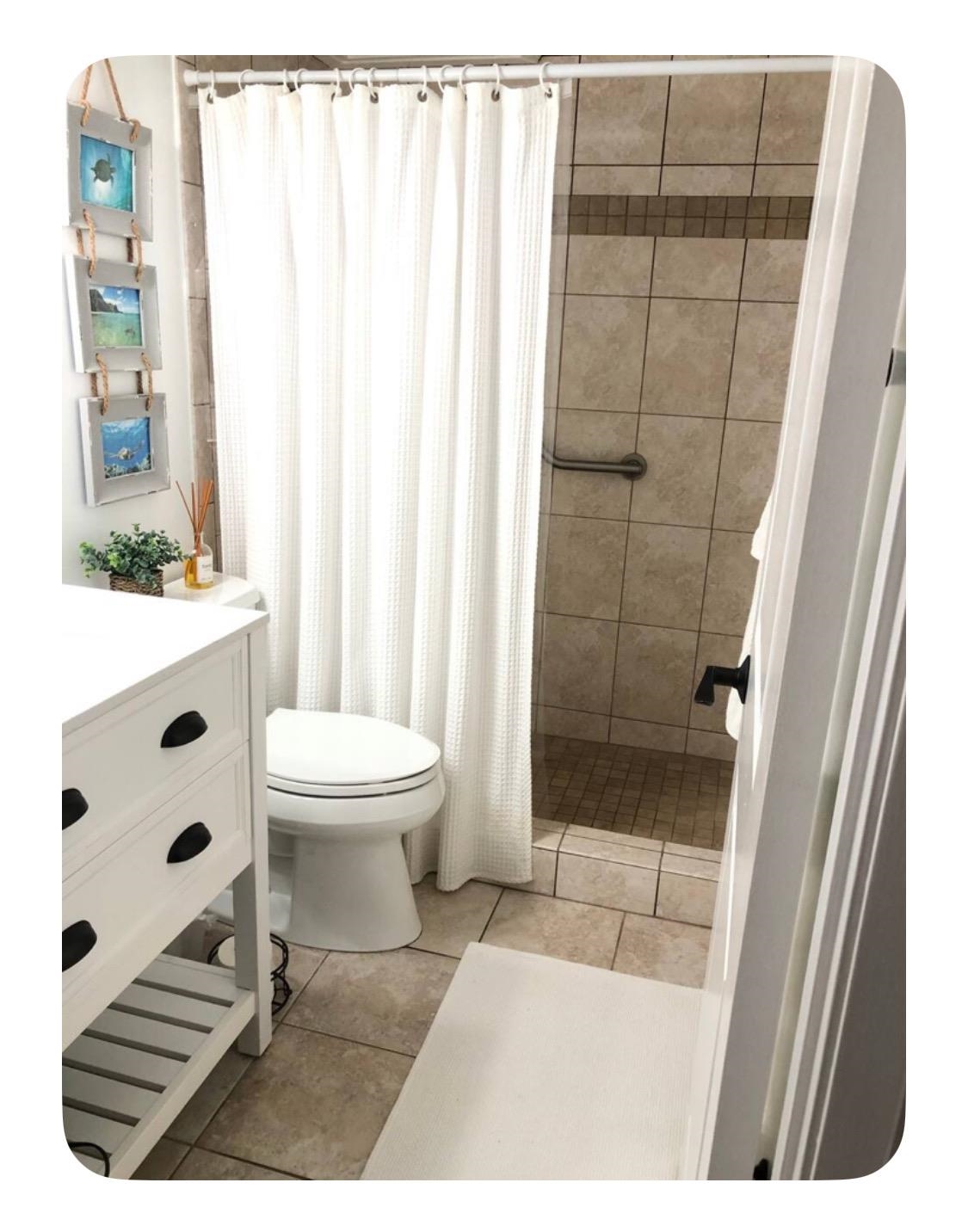120 Hui Rd F, Unit B5 Lahaina, HI 96761 - Photo 9 of 17 a bathroom with a sink a toilet a glass door and shower
