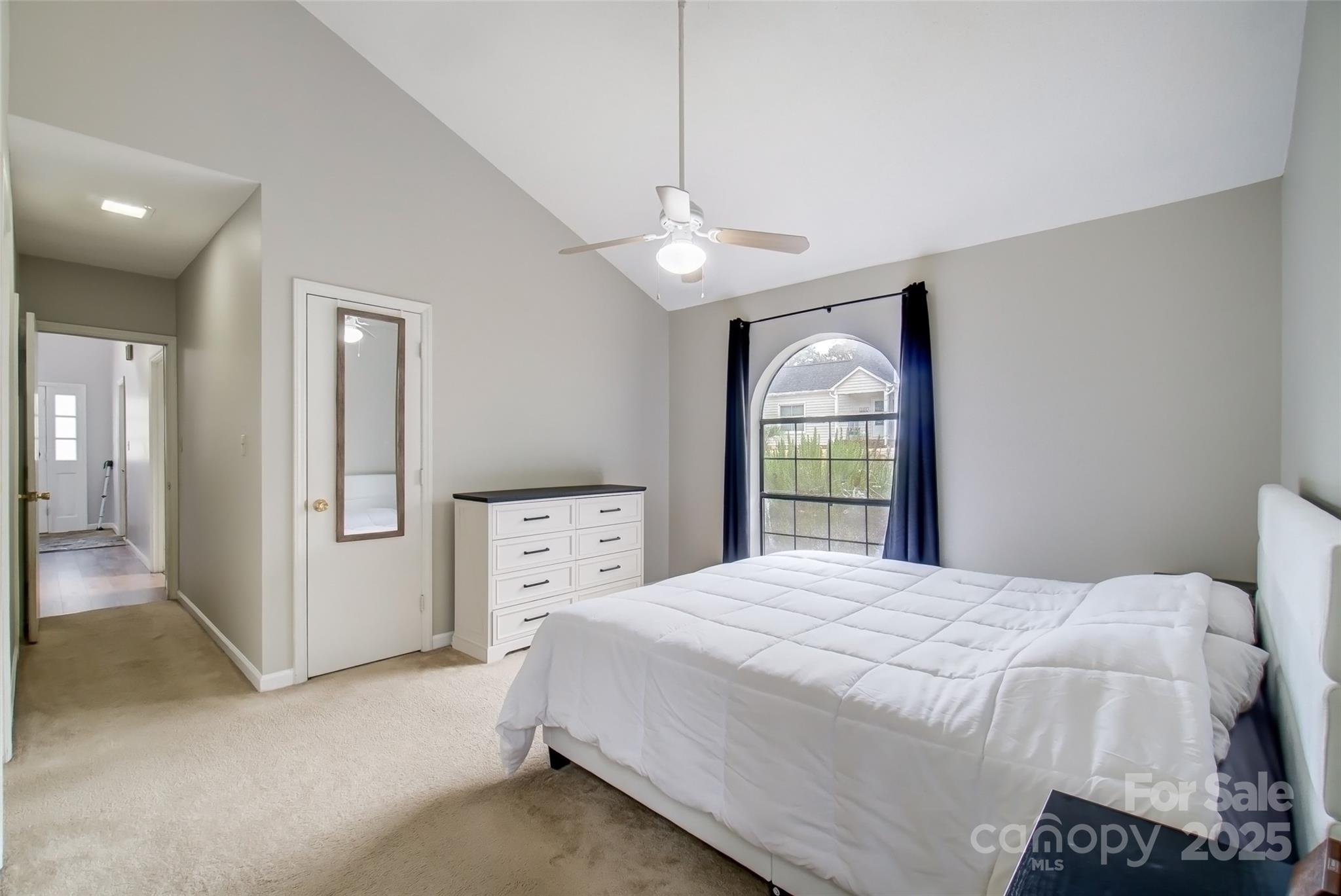 1205 Molokai Drive Tega Cay, SC 29708 - Photo 18 of 33 a bedroom with a large bed and a chandelier