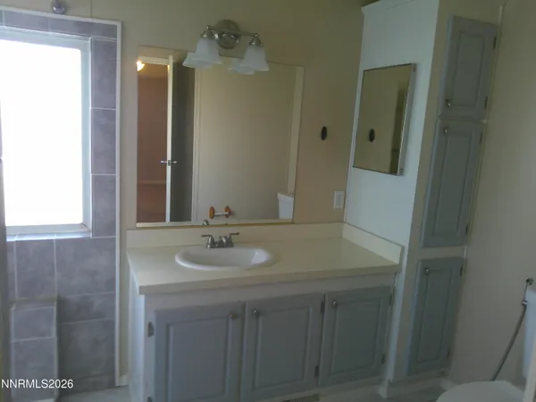 a bathroom with a sink toilet and mirror