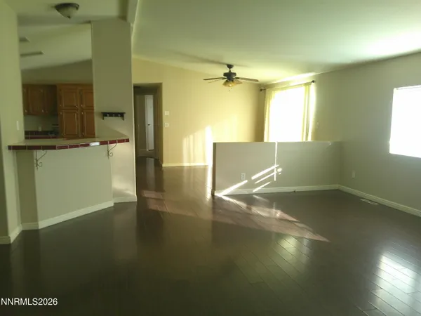 a view of empty room with wooden floor