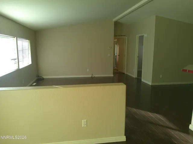 a room with a refrigerator freezer and a more window