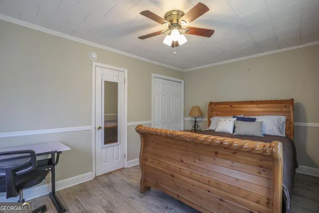a bedroom with a large bed a chandelier and closet