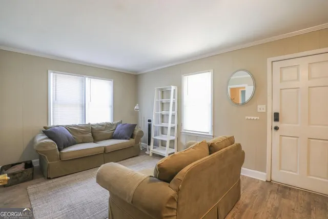 a living room with furniture a dining table and a fireplace