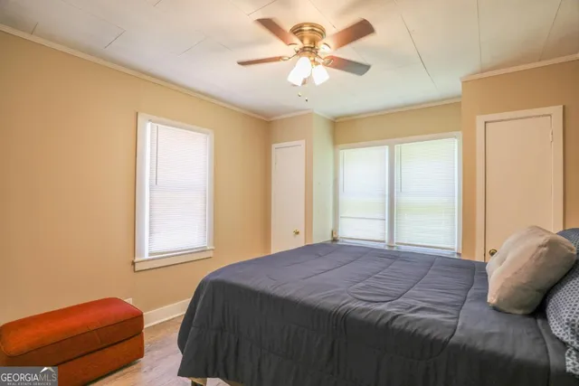 a bedroom with a bed and a chandelier