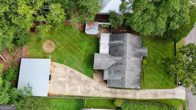 an aerial view of a house with garden space and sitting area