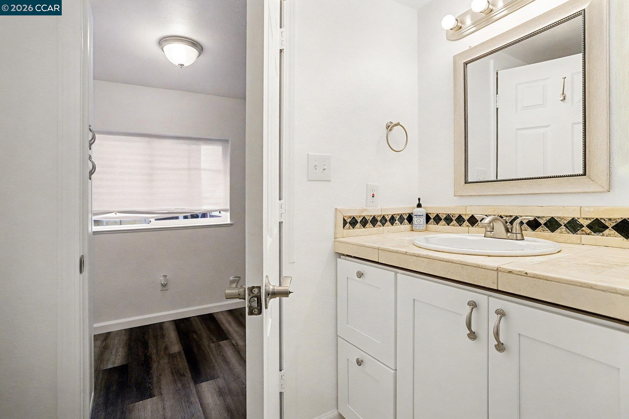 4041-4047 Ellis Road Martinez, CA 94553 - Photo 11 of 20 a bathroom with a sink and a mirror