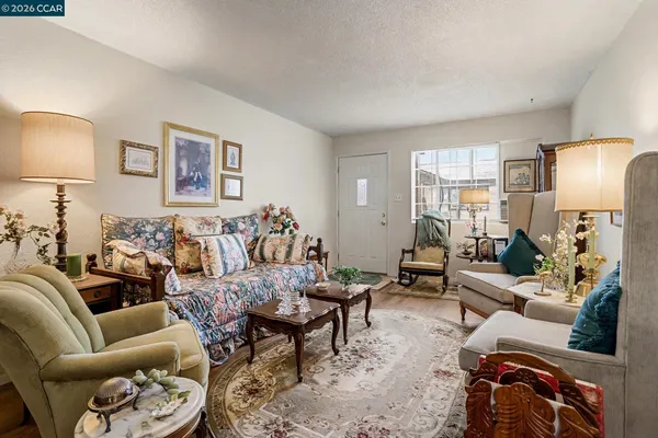a living room with furniture and a lamp