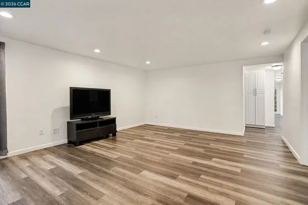 a living room with flat screen tv and a couch