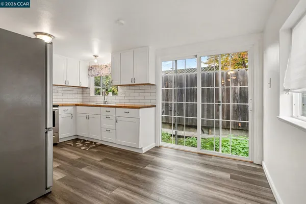 a kitchen with counter top space and wooden floor