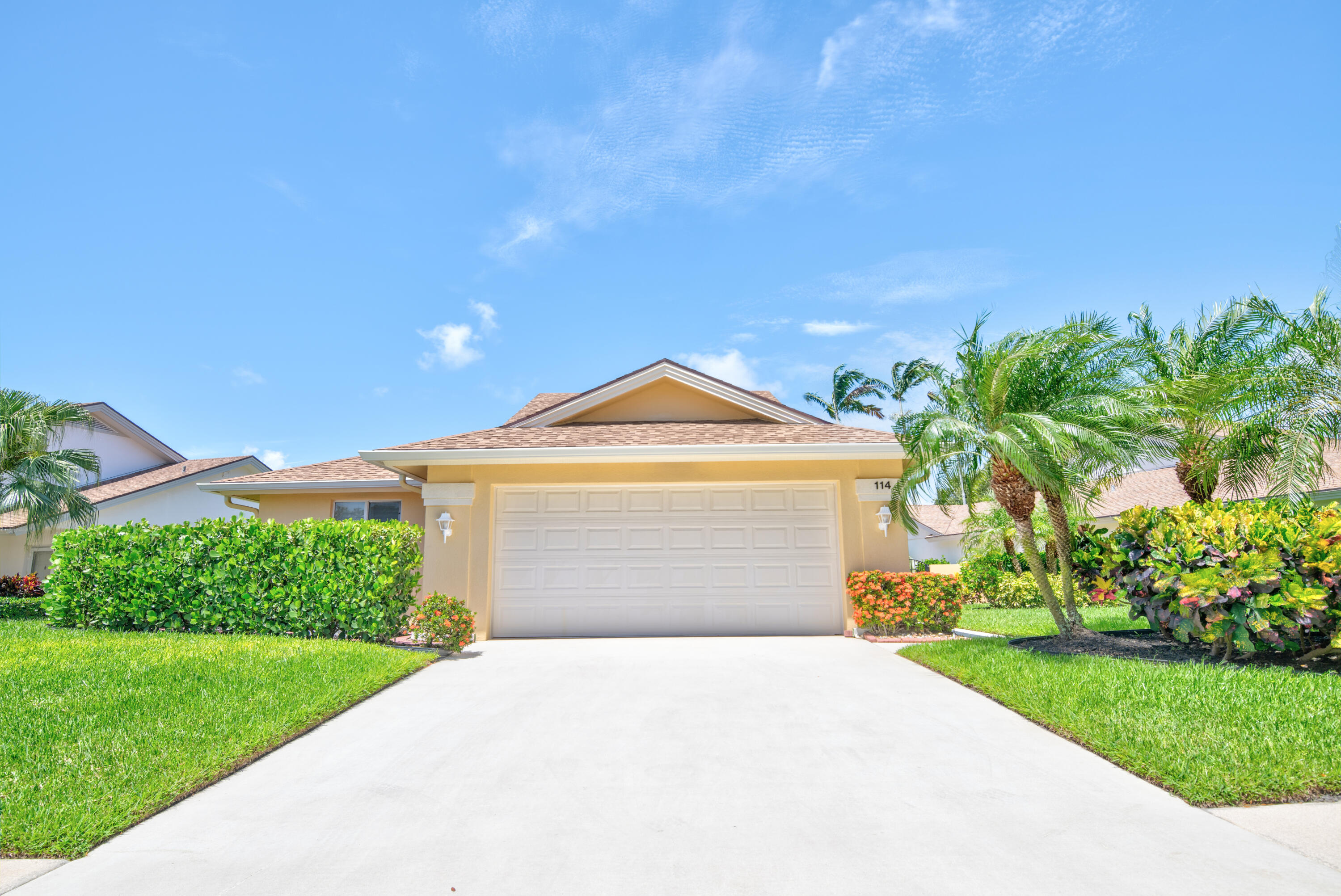 114 Beach Summit Court Jupiter, FL 33477 - Photo 6 of 97 a front view of a house with a yard and garage
