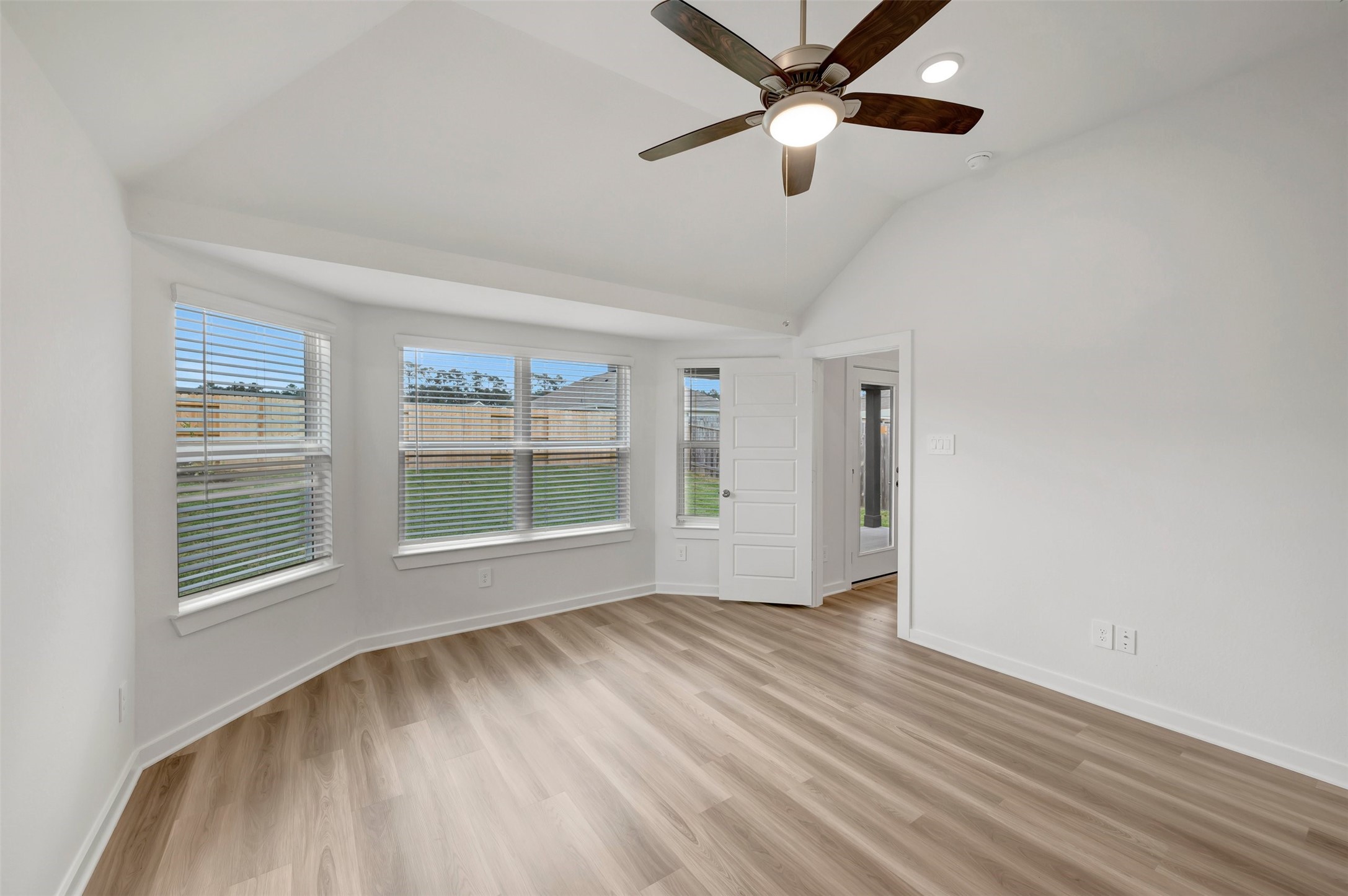 543 Flower Reed Court Magnolia, TX 77354 - Photo 4 of 46 an empty room with wooden floor fan and windows