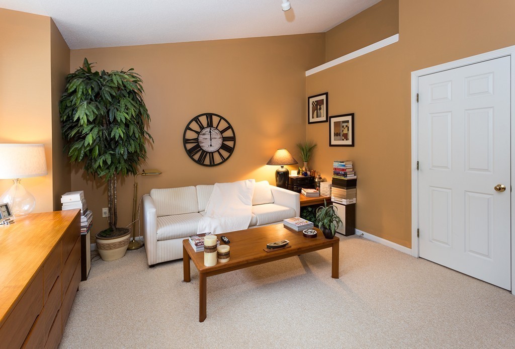 335 Bishops Forest Drive, Unit 335 Waltham, MA 02452 - Photo 12 of 21 a living room with furniture and a table