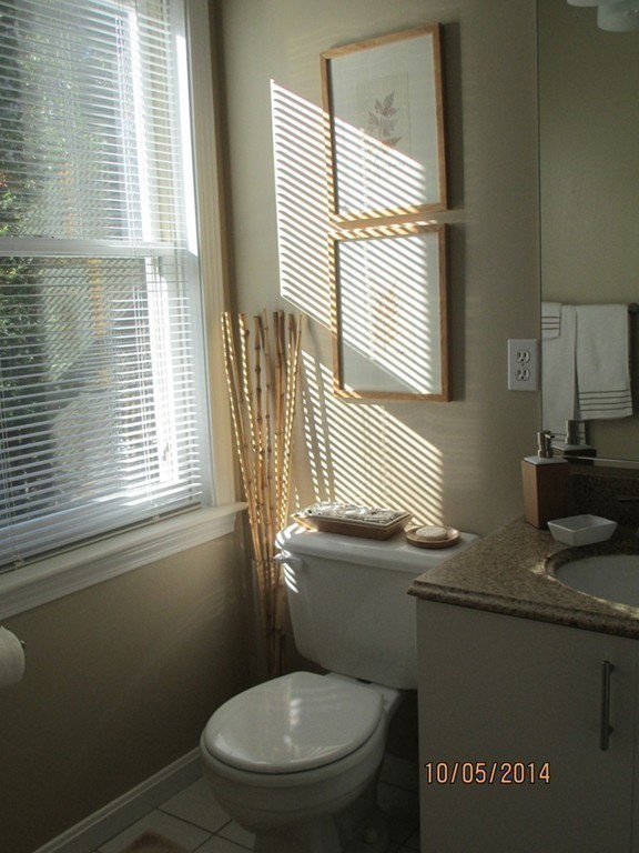 335 Bishops Forest Drive, Unit 335 Waltham, MA 02452 - Photo 16 of 21 a bathroom with a granite countertop toilet sink and mirror