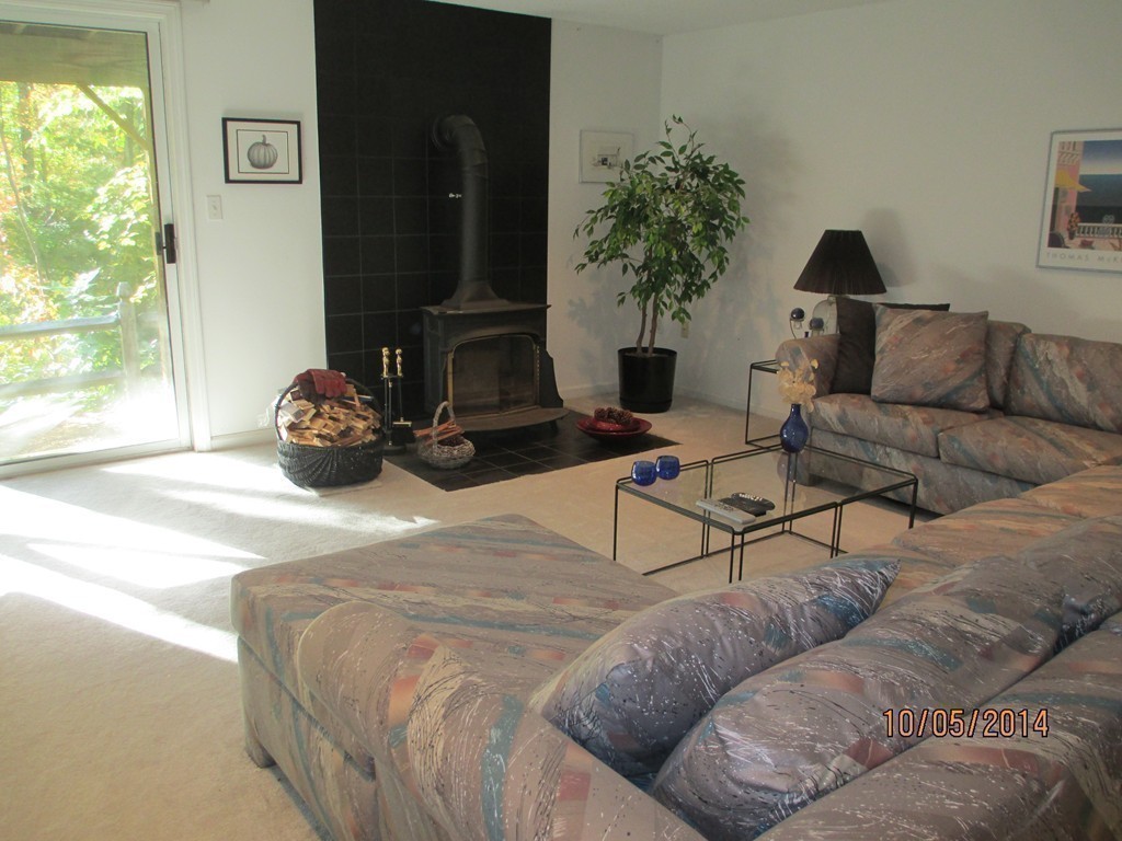 335 Bishops Forest Drive, Unit 335 Waltham, MA 02452 - Photo 18 of 21 a bedroom with furniture and a large window