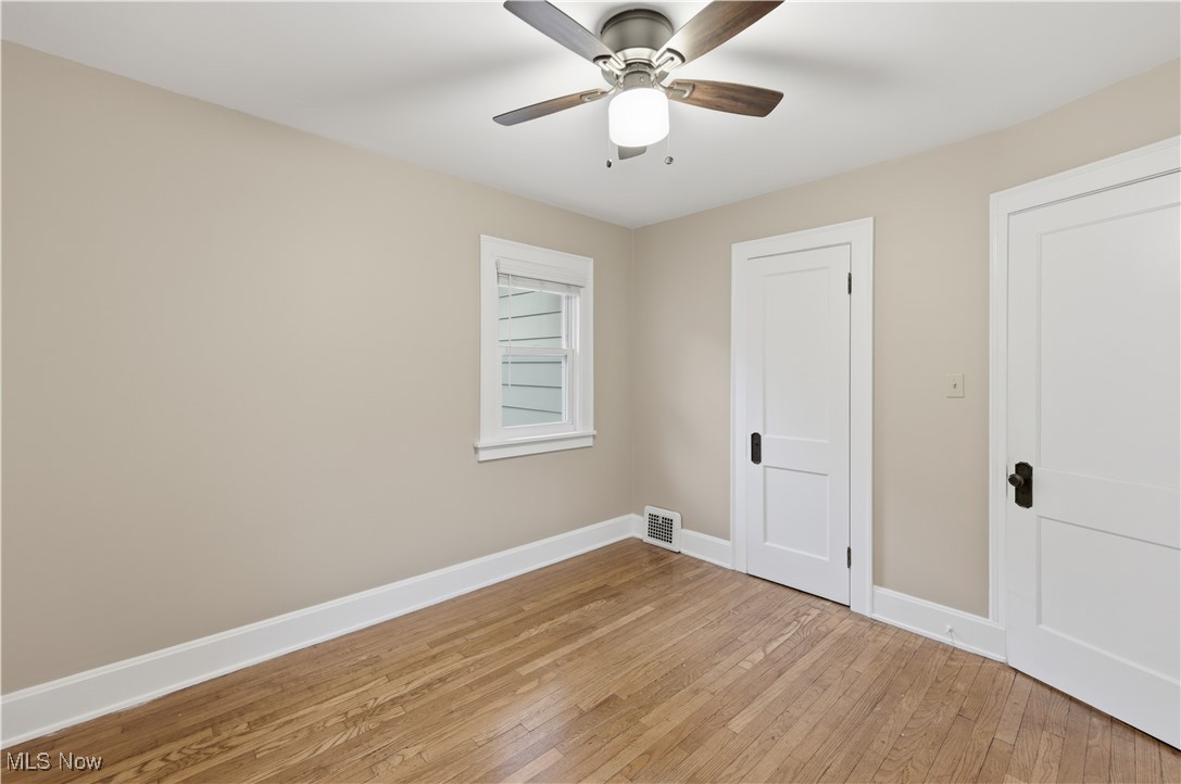 1017 Spring Road Cleveland, OH 44109 - Photo 30 of 47 Unfurnished room with hardwood / wood-style flooring and a ceiling fan