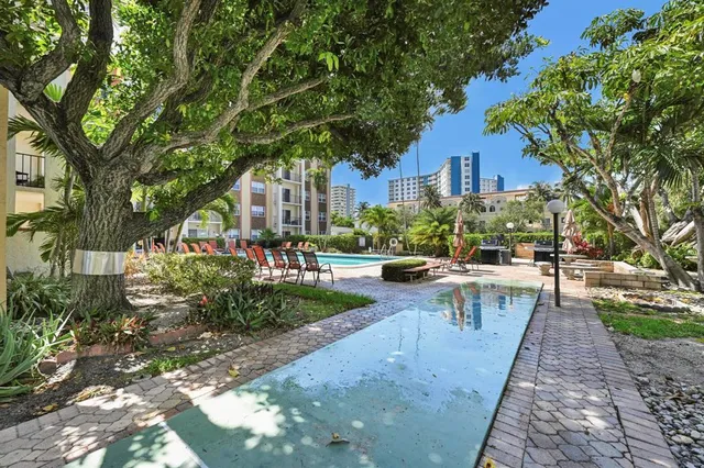 a view of a building with sitting area and garden