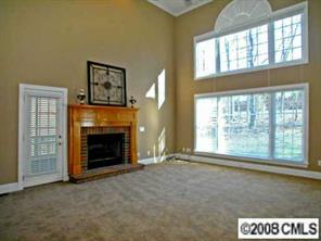 245 Edgewater Way Fort Mill, SC 29708 - Photo 4 of 8 a view of an empty room with a fireplace and a window