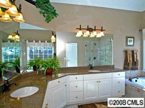 245 Edgewater Way Fort Mill, SC 29708 - Photo 8 of 8 a bathroom with a granite countertop sink a large mirror and a shower