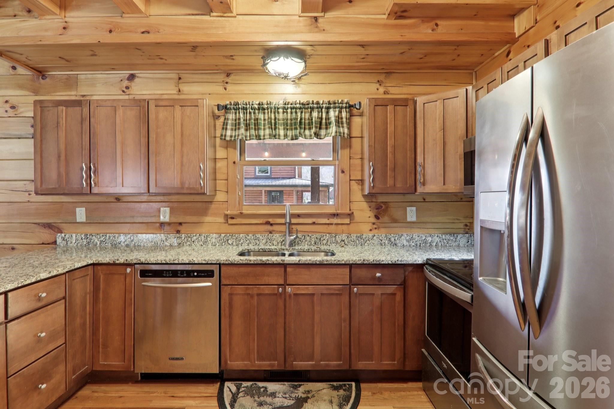 54 Meandering Way Maggie Valley, NC 28751 - Photo 12 of 47 a kitchen with stainless steel appliances granite countertop a refrigerator and a sink