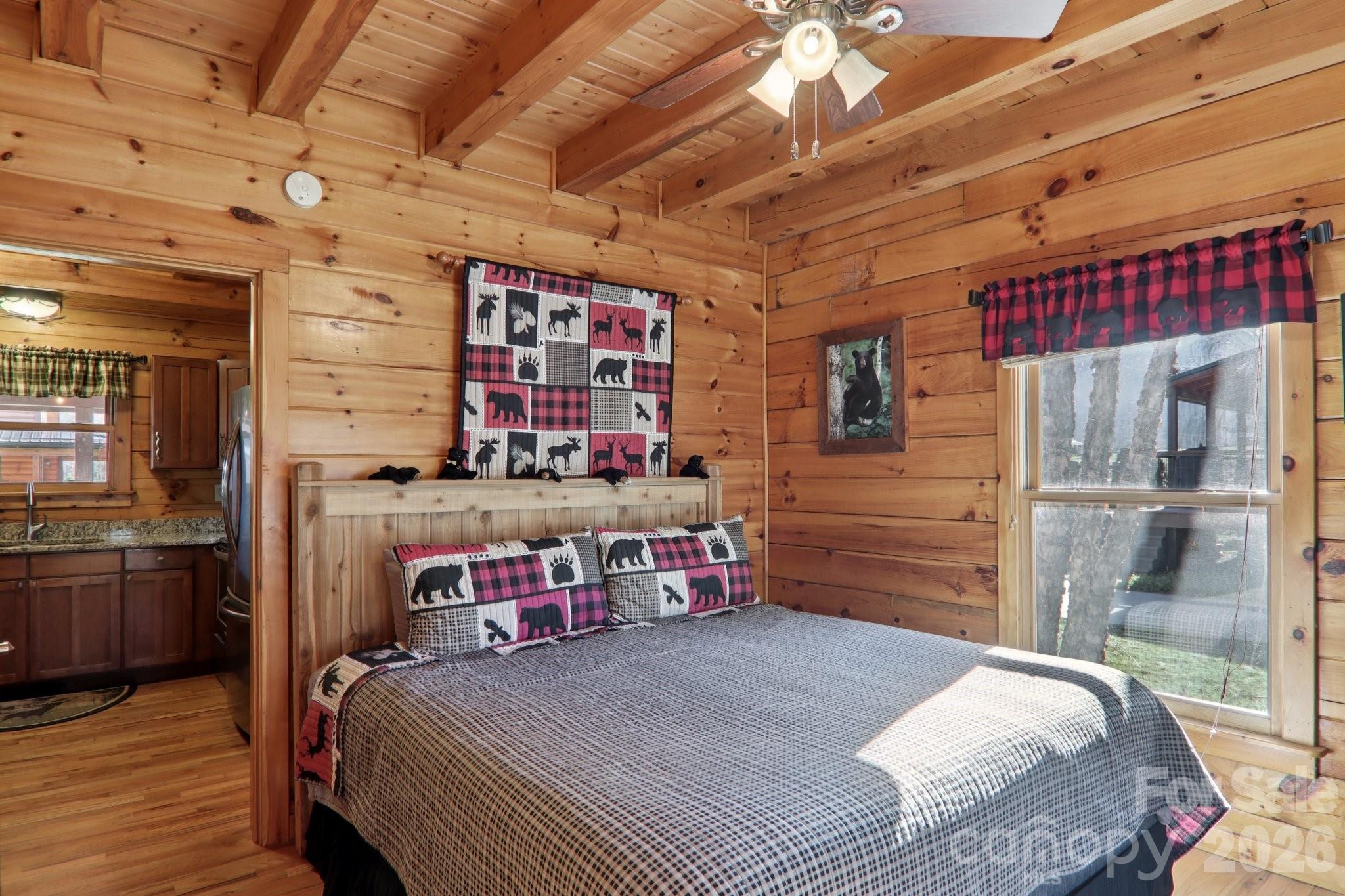 54 Meandering Way Maggie Valley, NC 28751 - Photo 15 of 47 a bedroom with a bed a dresser and next to a window