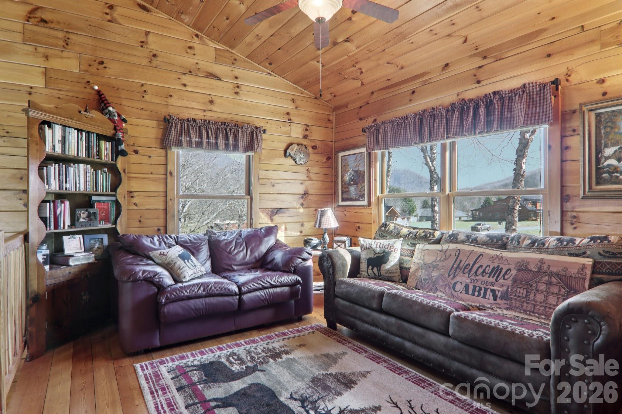 54 Meandering Way Maggie Valley, NC 28751 - Photo 19 of 47 a living room with furniture and a book shelf