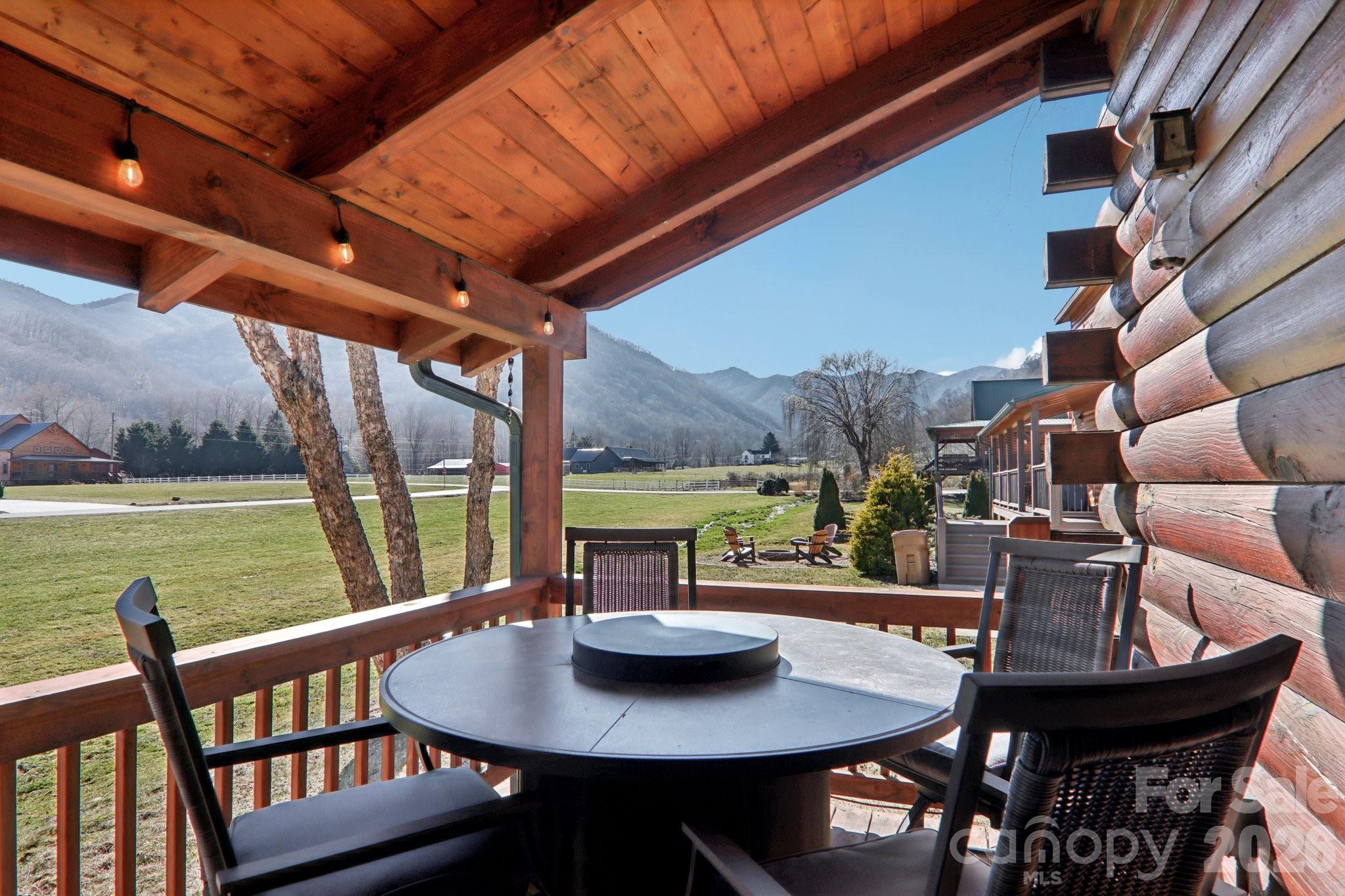 54 Meandering Way Maggie Valley, NC 28751 - Photo 32 of 47 a view of a patio with a table chairs and a table