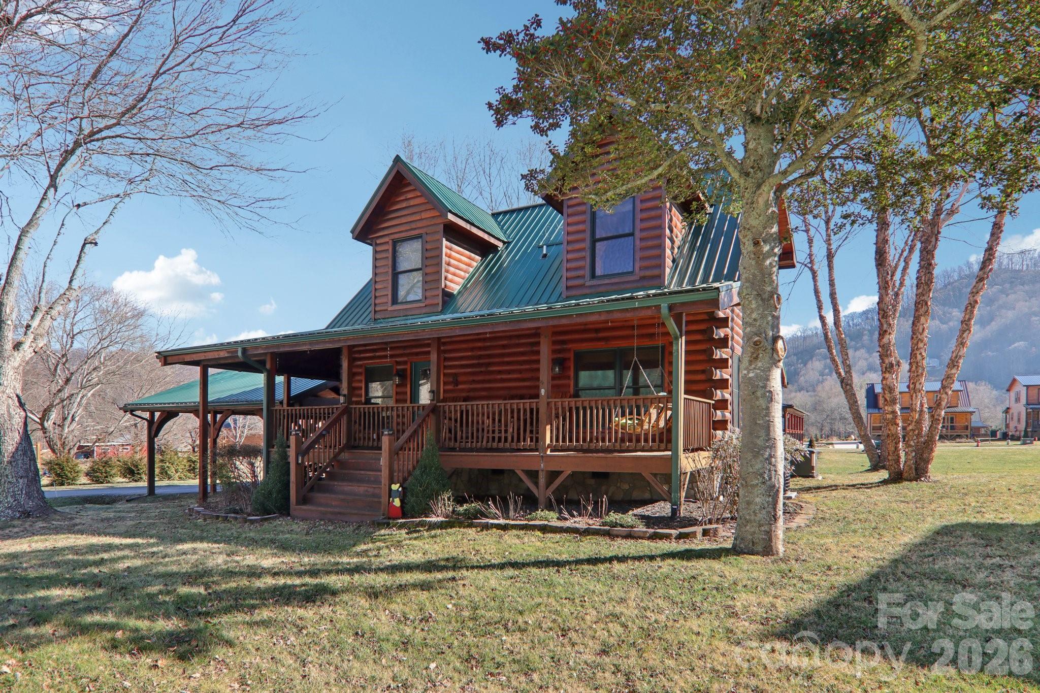54 Meandering Way Maggie Valley, NC 28751 - Photo 4 of 47 a front view of a house with garden