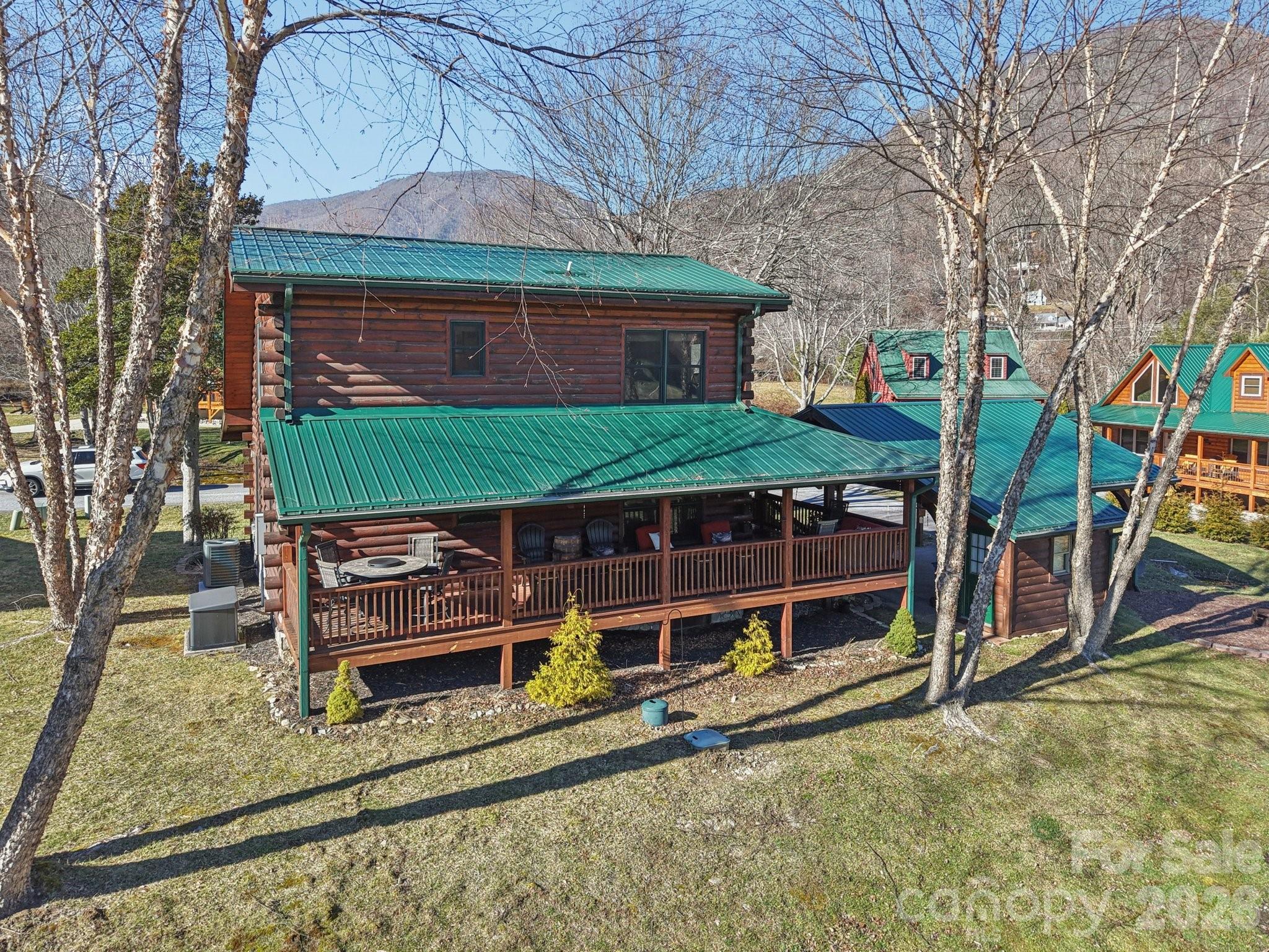 54 Meandering Way Maggie Valley, NC 28751 - Photo 45 of 47 a view of a house with a large window and wooden fence