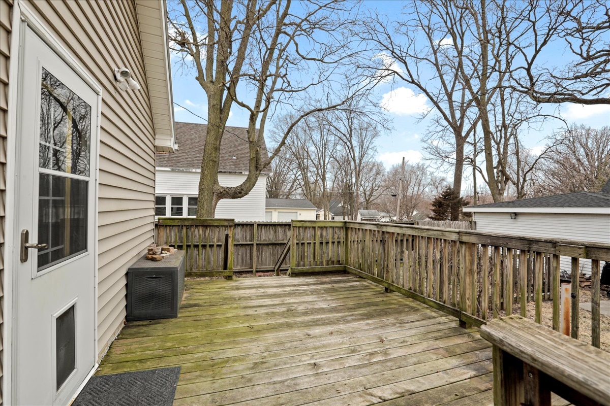712 Bell Street Bloomington, IL 61701 - Photo 14 of 14 a view of a balcony with wooden floor and fence and a table