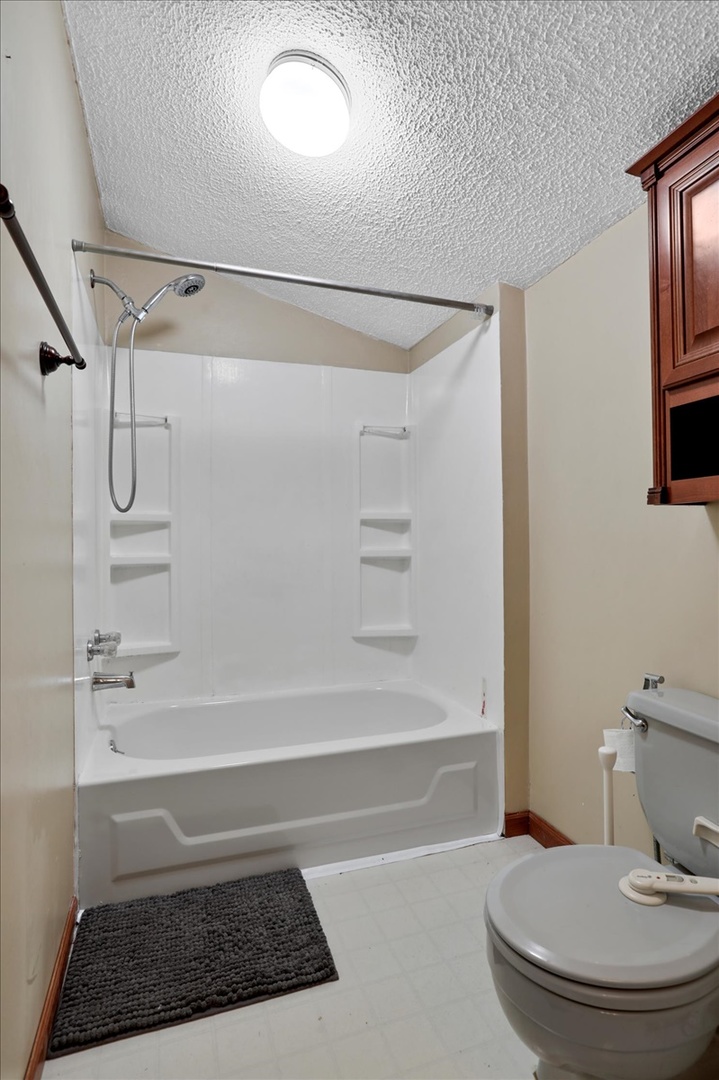 712 Bell Street Bloomington, IL 61701 - Photo 8 of 14 a bathroom with a sink a toilet and shower