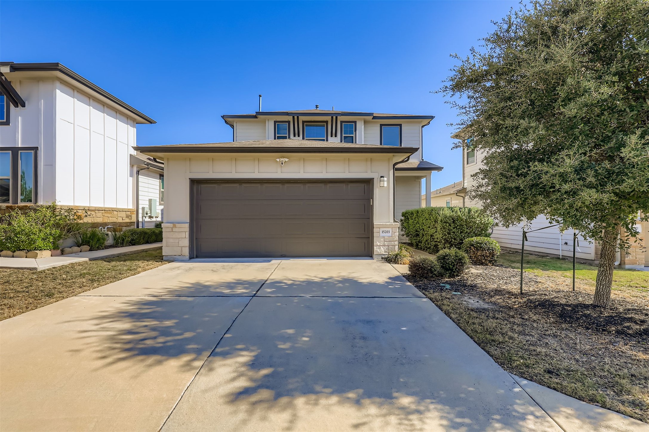 15203 Wallaby Way Austin, TX 78728 - Photo 1 of 26 a front view of a house with a yard and garage