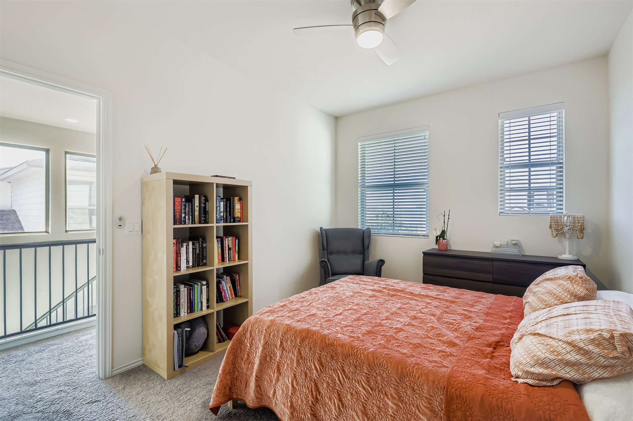 15203 Wallaby Way Austin, TX 78728 - Photo 20 of 26 a bedroom with a bed a dresser and a book shelf