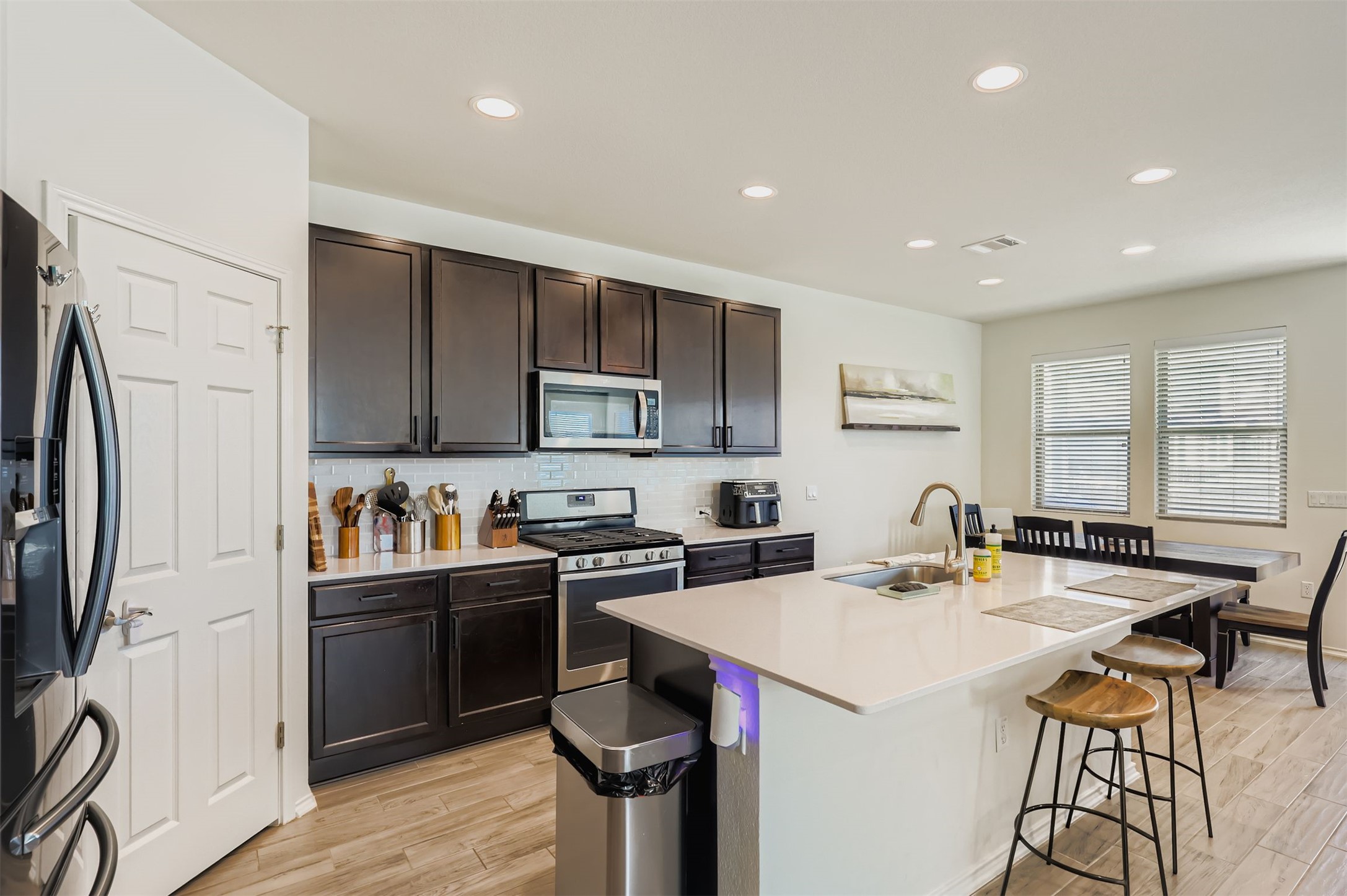 15203 Wallaby Way Austin, TX 78728 - Photo 7 of 26 a kitchen with a sink a stove a refrigerator and cabinets