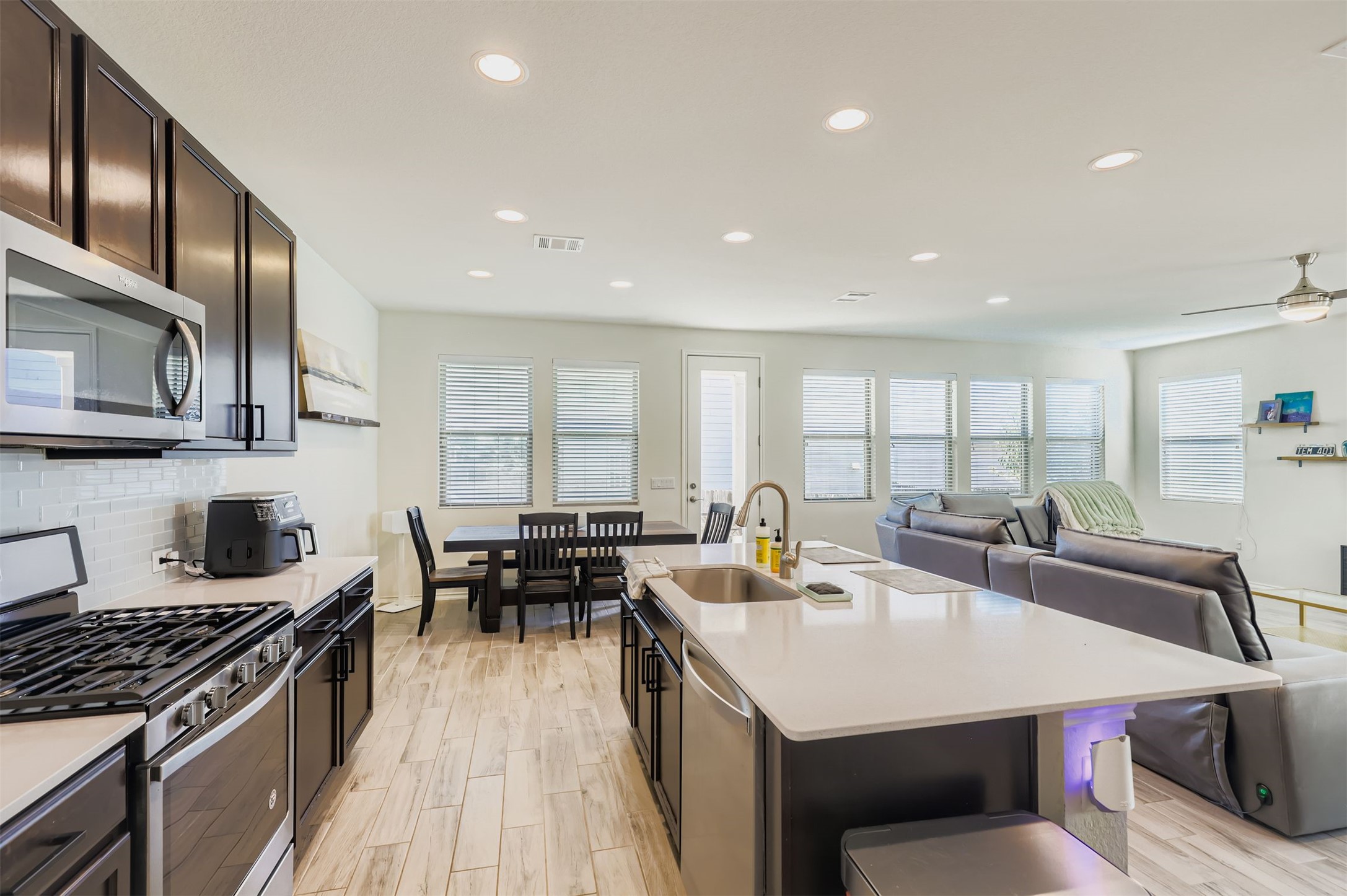 15203 Wallaby Way Austin, TX 78728 - Photo 8 of 26 a kitchen with counter space sink stove and chairs