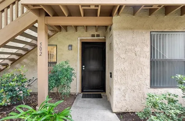 front view of a house with a potted plant and garage