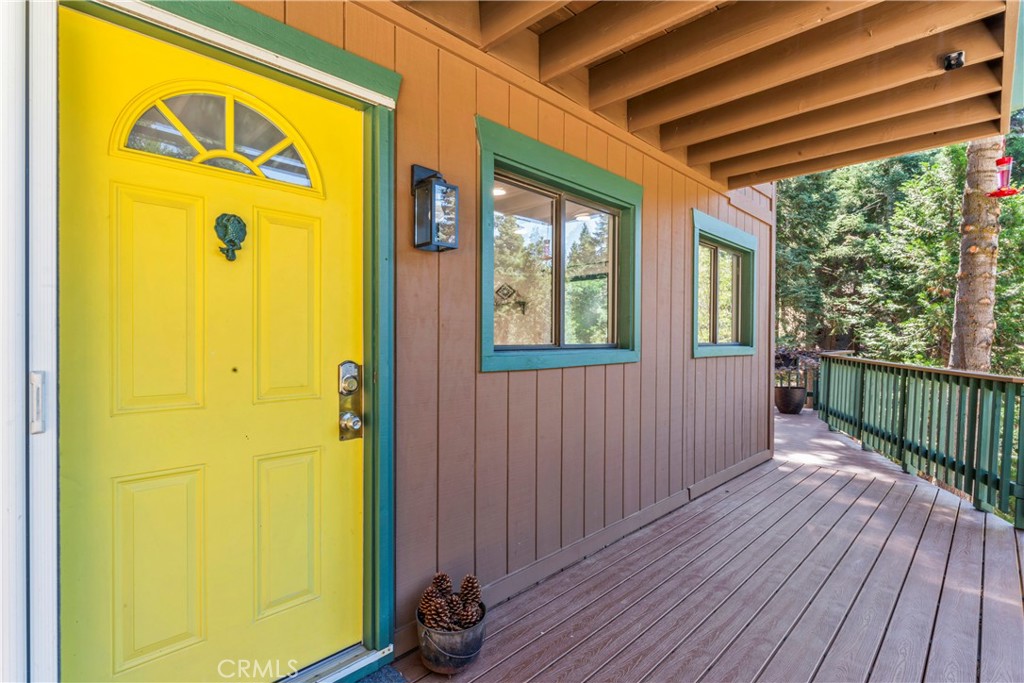 899 Blue Ridge Drive Lake Arrowhead, CA 92385 - Photo 2 of 49 a view of a porch with wooden floor and a door
