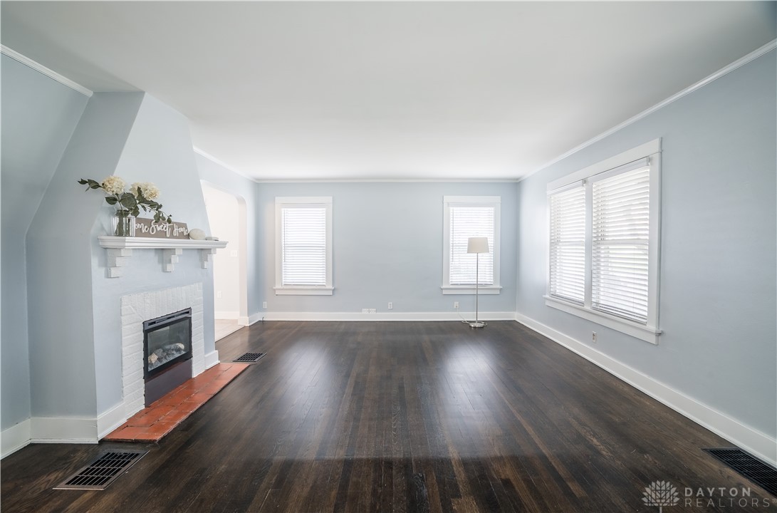 This inviting living space features rich hardwood floors, a charming fireplace, and abundant natural light.
