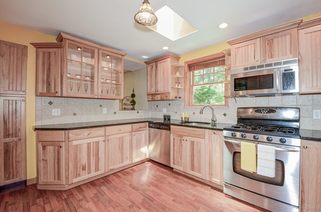 32 Old Shirley Road Harvard, MA 01451 - Photo 3 of 23 a kitchen with stainless steel appliances granite countertop a stove sink microwave and cabinets