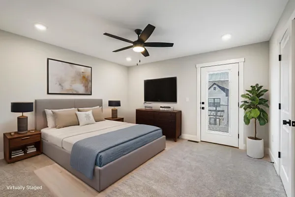 an empty room with closet and a ceiling fan