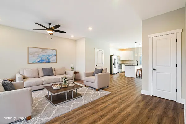a living room with furniture and a wooden floor