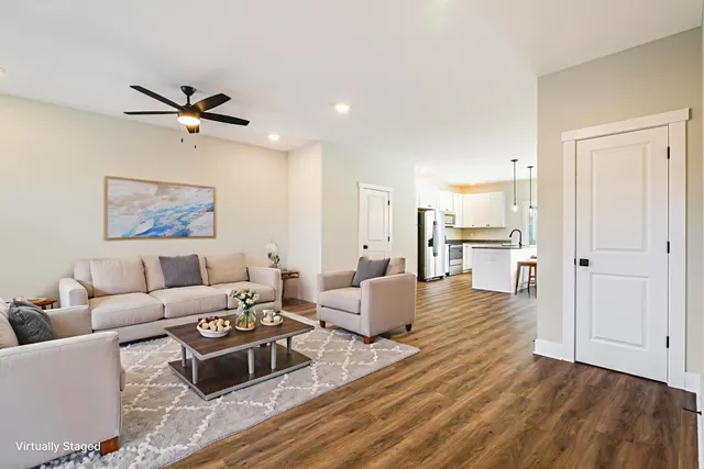 a living room with furniture and a wooden floor