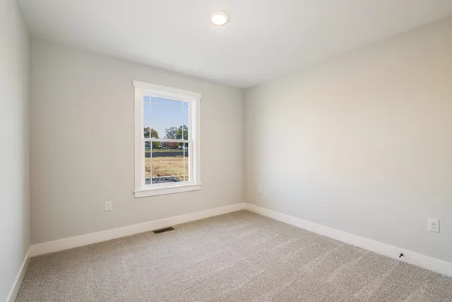 a front view of a house with a yard and ocean view