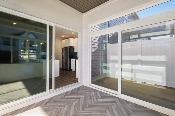 a kitchen with stainless steel appliances granite countertop a sink a stove and a wooden floor