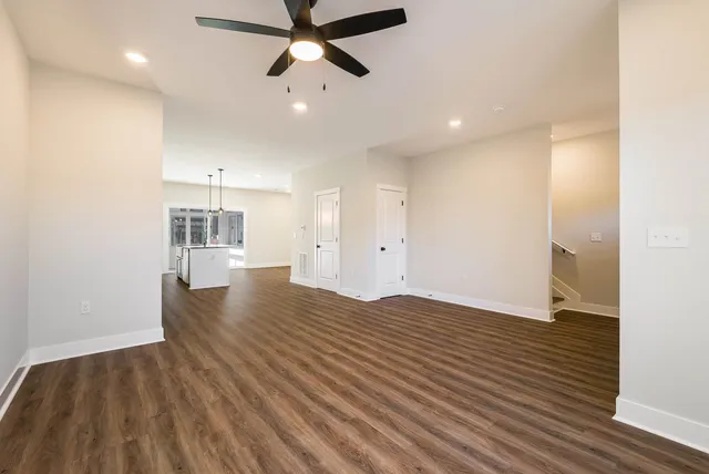 a view of empty room with wooden floor and window