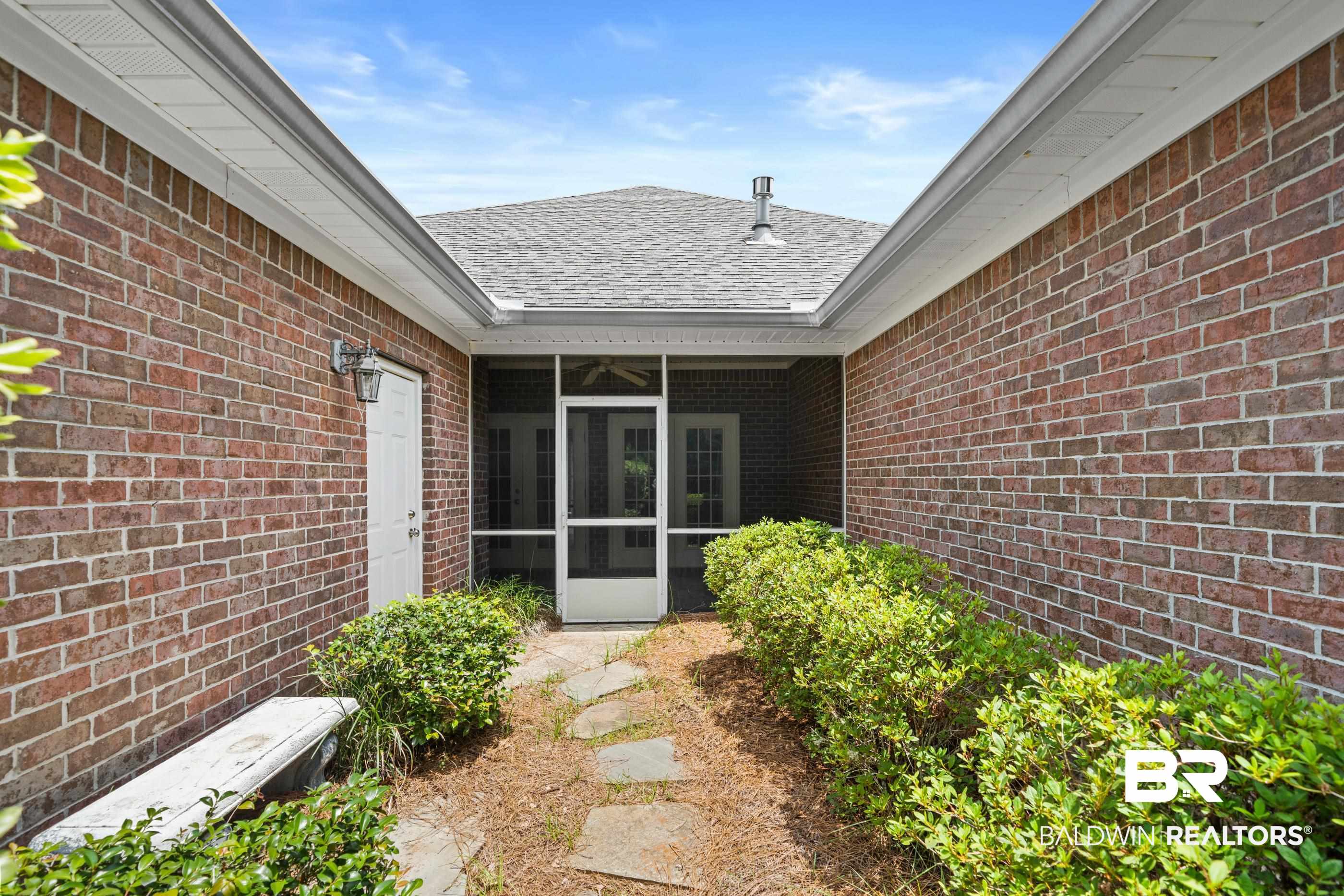 303 Savannah Circle Foley, AL 36535 - Photo 28 of 34 Brick exterior with a covered entry leading to a screened porch