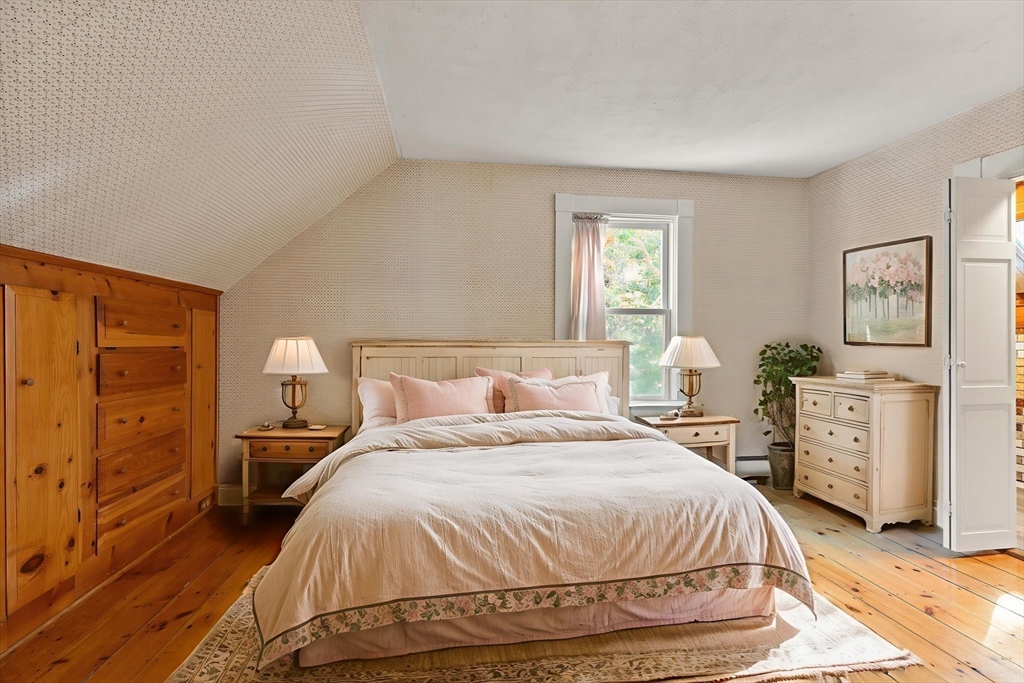 214 Graniteville Road Chelmsford, MA 01824 - Photo 28 of 42 a bedroom with a bed and wooden floor