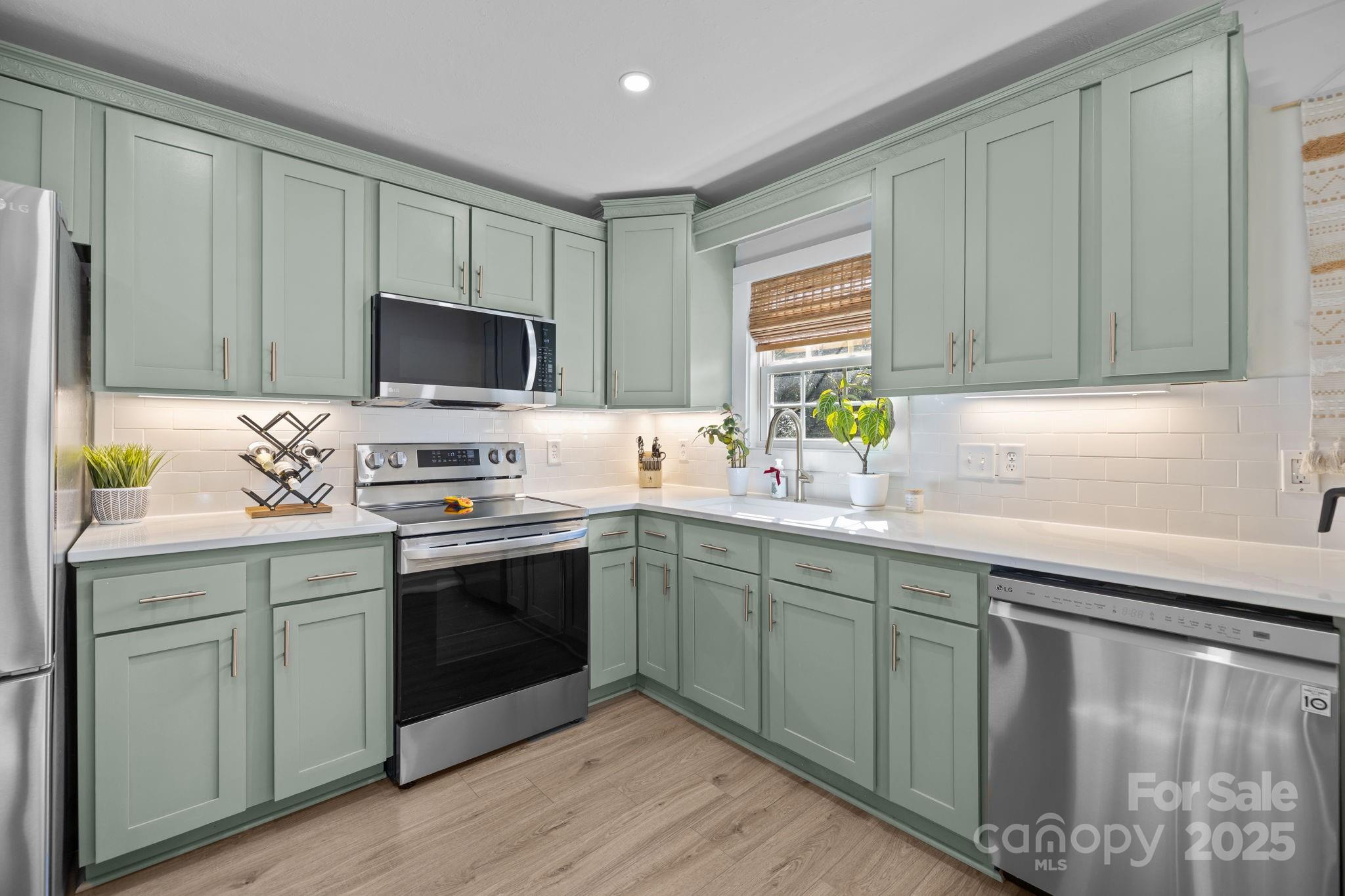 5509 Southampton Road Charlotte, NC 28217 - Photo 10 of 35 a kitchen with stainless steel appliances granite countertop a stove a sink and a microwave
