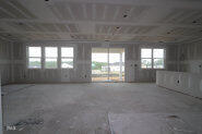 256 Yellow River Way Garner, NC 27529 - Photo 17 of 23 an empty room with windows