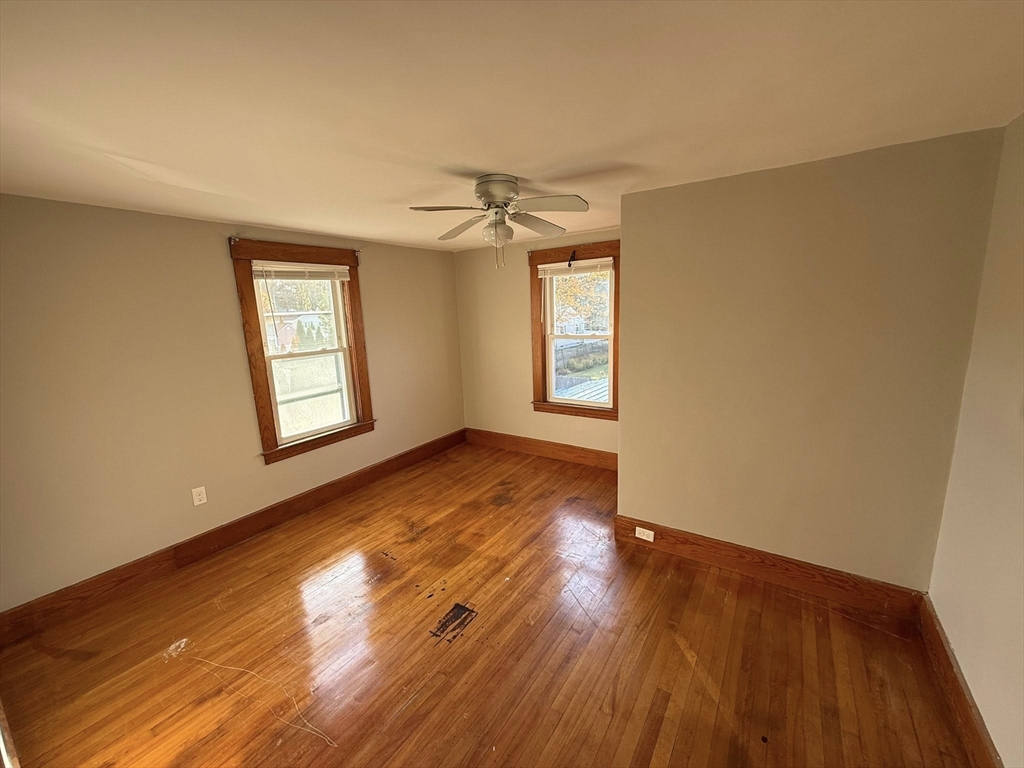 306 Franklin Road, Unit 2 Fitchburg, MA 01420 - Photo 11 of 17 an empty room with wooden floor and windows